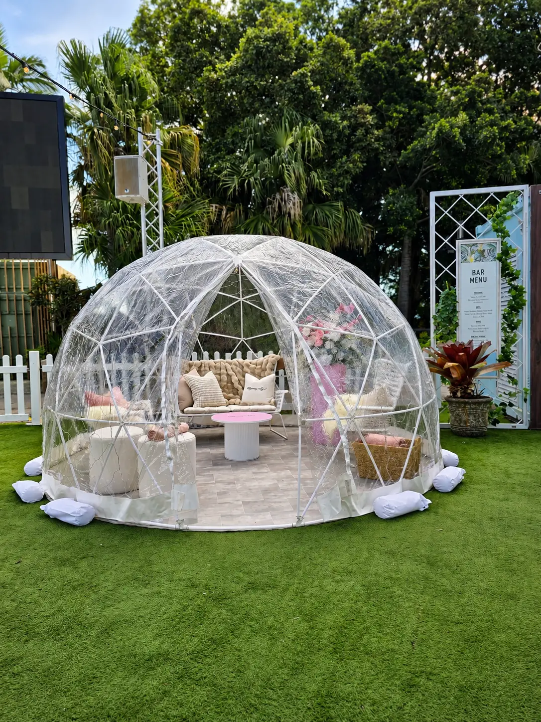 Pop-up activation with clear dome and lounge styling on lawn