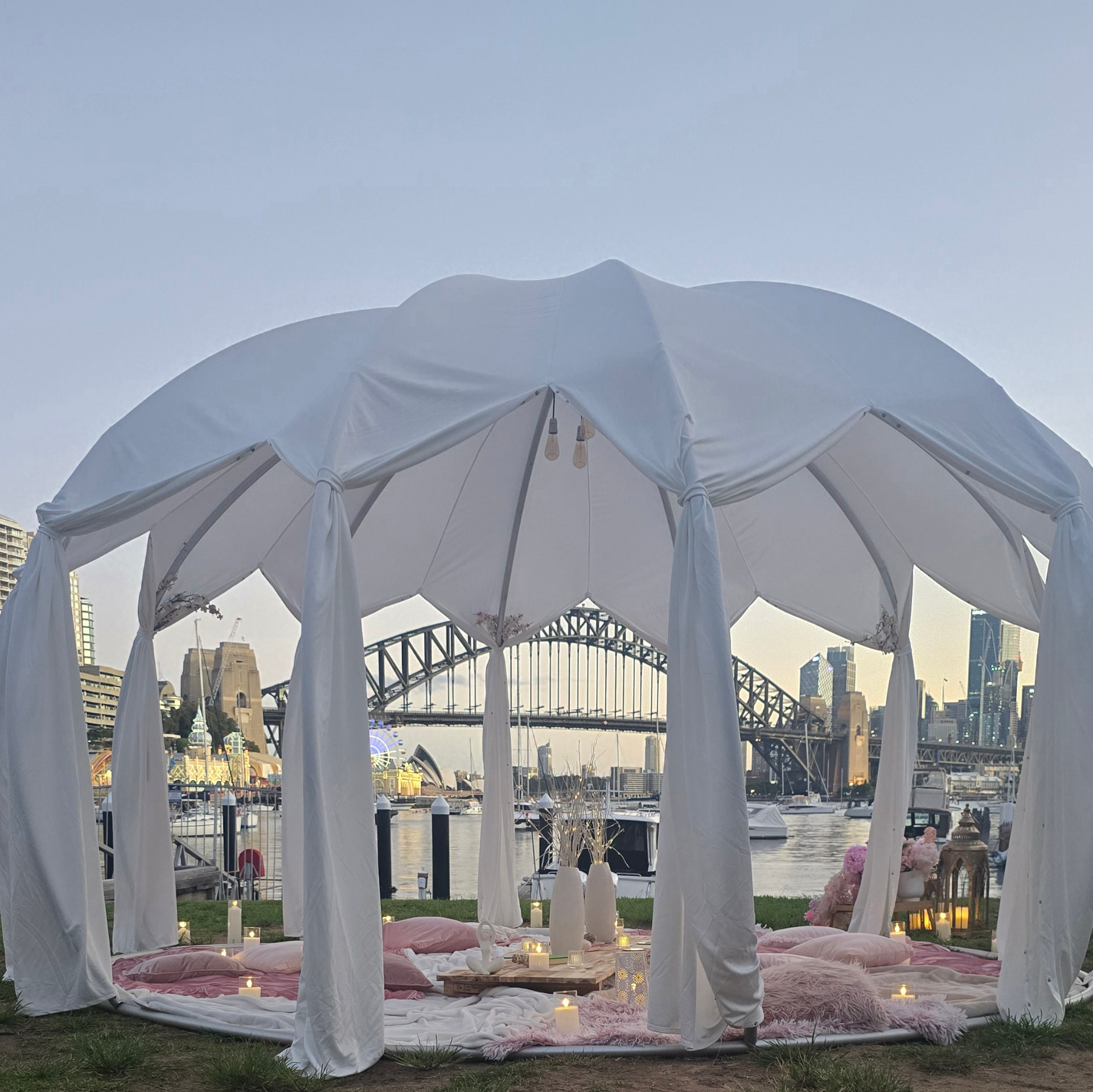 IGLOOZE Cabana canopy at dusk overlooking Sydney Harbour with candles and florals