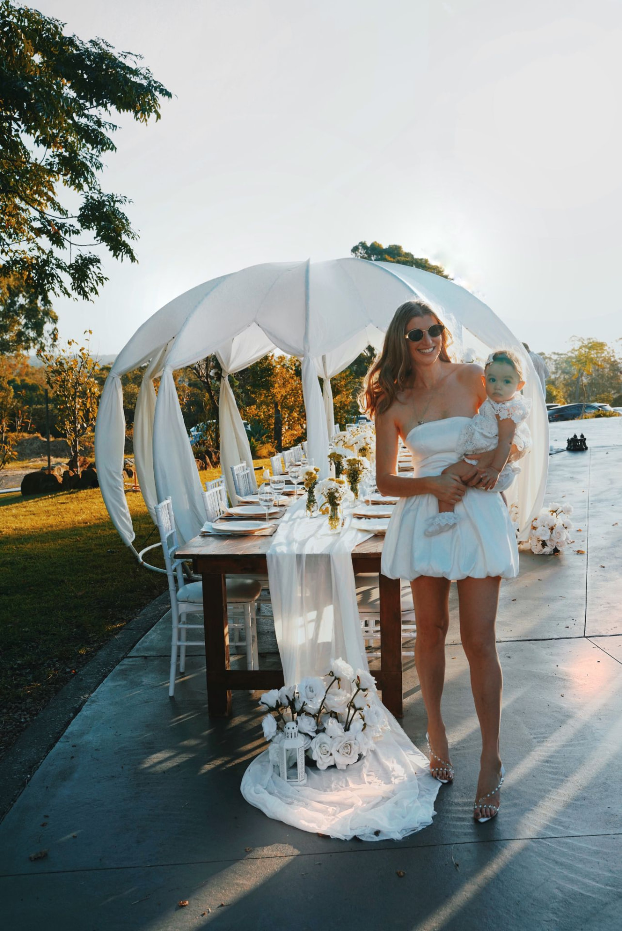 IGLOOZE white cabana styled for a garden celebration with a long dining table
